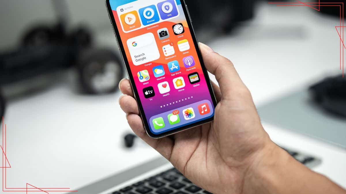Mobile phone displaying apps on a colorful home screen, with a blurred office background – SEO keywords focused on mobile apps, smartphone, technology, and digital tools.